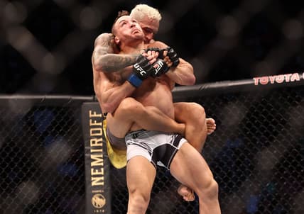 May 15, 2021; Houston, Texas, USA; Charles Oliveira brings down Michael Chandler during UFC 262 at Toyota Center. Mandatory Credit: Troy Taormina-USA TODAY Sports