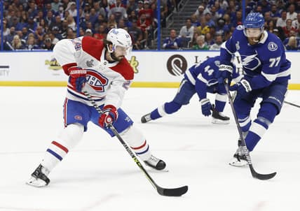 Jun 28, 2021; Tampa, Florida, USA; Montreal Canadiens left wing Phillip Danault (24) skates with the puck against Tampa Bay Lightning defenseman Victor Hedman (77) in the first period of game one of the 2021 Stanley Cup Final at Amalie Arena. Mandatory Credit: Kim Klement-USA TODAY Sports