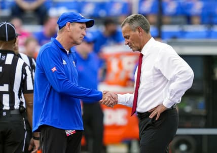 Sep 3, 2021; Lawrence, Kansas, USA; Kansas Jayhawks head coach Lance Leipold (left) shakes hands with South Dakota Coyotes head coach Bob Nielson before a game at David Booth Kansas Memorial Stadium. Mandatory Credit: Jay Biggerstaff-USA TODAY Sports