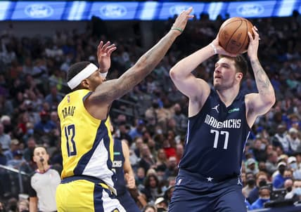 Jan 29, 2022; Dallas, Texas, USA;  Dallas Mavericks guard Luka Doncic (77) shoots as Indiana Pacers forward Torrey Craig (13) defends during the second quarter at American Airlines Center. Mandatory Credit: Kevin Jairaj-USA TODAY Sports