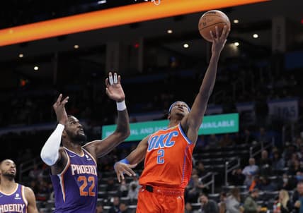 Feb 24, 2022; Oklahoma City, Oklahoma, USA; Oklahoma City Thunder guard Shai Gilgeous-Alexander (2) goes to the basket ahead of Phoenix Suns center Deandre Ayton (22) during the first quarter at Paycom Center. Mandatory Credit: Alonzo Adams-USA TODAY Sports