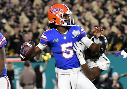 Dec 23, 2021; Tampa, FL, USA;  Florida Gators quarterback Emory Jones (5) is hit by UCF Knights defensive lineman Big Kat Bryant (1) on a pass attempt in the first half of the Gasparilla Bowl at Raymond James Stadium. Mandatory Credit: Jonathan Dyer-USA TODAY Sports
