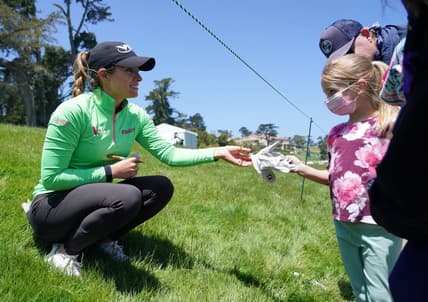 Jun 6, 2021; San Francisco, California, USA; Gaby Lopez gives a signed glove to a young golf spectator during the final round of the U.S. Women's Open golf tournament at The Olympic Club. Mandatory Credit: Kyle Terada-USA TODAY Sports