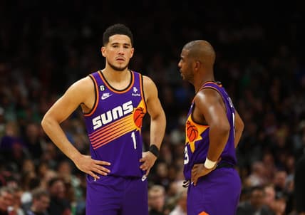 Dec 7, 2022; Phoenix, Arizona, USA; Phoenix Suns guard Devin Booker (1) and Chris Paul (3) against the Boston Celtics at Footprint Center. Mandatory Credit: Mark J. Rebilas-USA TODAY Sports