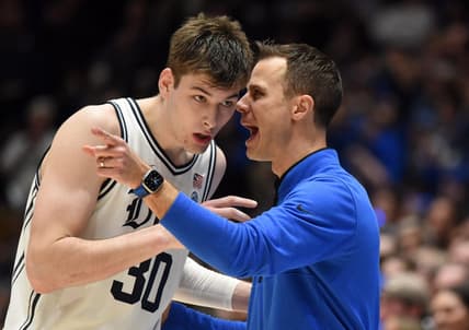 Feb 4, 2023; Durham, North Carolina, USA; Duke Blue Devils head coach Jon Scheyer (right) talks to center Kyle Filipowski(30) during the second half against the North Carolina Tar Heels at Cameron Indoor Stadium.  The Blue Devils won 63-57. Mandatory Credit: Rob Kinnan-USA TODAY Sports