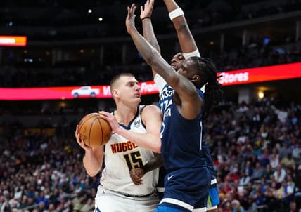 Feb 7, 2023; Denver, Colorado, USA; Minnesota Timberwolves forward Taurean Prince (12) and center Naz Reid (11) defend on Denver Nuggets center Nikola Jokic (15) in the second quarter at Ball Arena. Mandatory Credit: Ron Chenoy-USA TODAY Sports