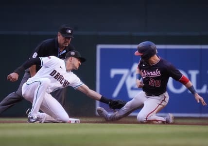 May 6, 2023; Phoenix, AZ, USA; Arizona Diamondbacks short stop Nick Ahmed (13) tags out Washington Nationals' Lane Thomas (28) on a steal attempt at Chase Field.