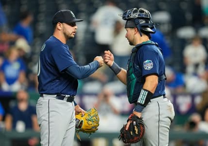 Aug 15, 2023; Kansas City, Missouri, USA; Seattle Mariners relief pitcher Tayler Saucedo (60) celebrates with catcher Cal Raleigh (29) after defeating the Kansas City Royals at Kauffman Stadium. Mandatory Credit: Jay Biggerstaff-USA TODAY Sports