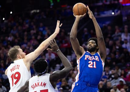 Nov 2, 2023; Philadelphia, Pennsylvania, USA; Philadelphia 76ers center Joel Embiid (21) shoots the ball past Toronto Raptors center Jakob Poeltl (19) and forward Pascal Siakam (43) during the second quarter at Wells Fargo Center. Mandatory Credit: Bill Streicher-USA TODAY Sports