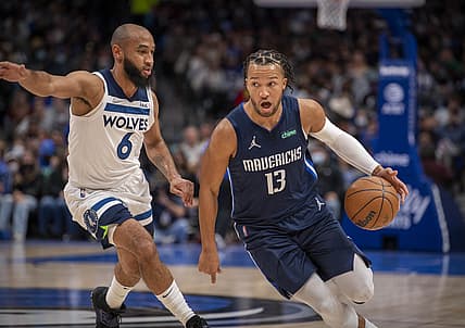 Dec 21, 2021; Dallas, Texas, USA; Dallas Mavericks guard Jalen Brunson (13) brings the ball up court past Minnesota Timberwolves guard Jordan McLaughlin (6) during the second quarter at the American Airlines Center. Mandatory Credit: Jerome Miron-USA TODAY Sports
