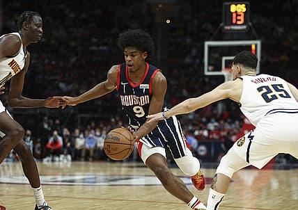 Jan 1, 2022; Houston, Texas, USA; Houston Rockets guard Josh Christopher (9) dribbles the ball as Denver Nuggets guard Austin Rivers (25) defends during the second quarter at Toyota Center. Mandatory Credit: Troy Taormina-USA TODAY Sports