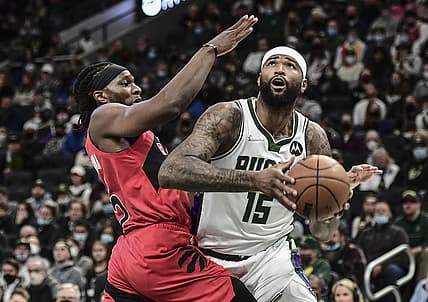 Jan 5, 2022; Milwaukee, Wisconsin, USA; Milwaukee Bucks center DeMarcus Cousins (15) looks for a shot against Toronto Raptors forward Precious Achiuwa (5) in the second quarter at Fiserv Forum. Mandatory Credit: Benny Sieu-USA TODAY Sports