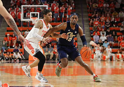 Mar 2, 2022; Clemson, South Carolina, USA; Georgia Tech Yellow Jackets foward Khalid Moore (12) dribbles the ball as Clemson Tigers guard David Collins (13) defends during the first half at Littlejohn Coliseum. Mandatory Credit: Dawson Powers-USA TODAY Sports
