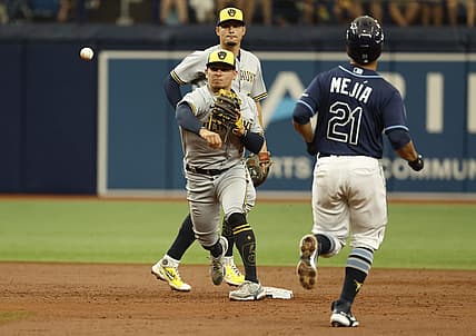 Jun 29, 2022; St. Petersburg, Florida, USA;  Milwaukee Brewers shortstop Luis Urias (2) forces out Tampa Bay Rays catcher Francisco Mejia (21) and throws the ball to first base for a double play during the third inning sat Tropicana Field. Mandatory Credit: Kim Klement-USA TODAY Sports