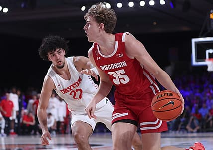 Nov 23, 2022; Paradise Island, BAHAMAS; Wisconsin Badgers forward Markus Ilver (35) dribbles as Dayton Flyers forward Mustapha Amzil (22) defends during the second half at Imperial Arena. Mandatory Credit: Kevin Jairaj-USA TODAY Sports