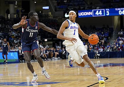 Jan 29, 2022; Chicago, Illinois, USA; DePaul Blue Demons forward Javan Johnson (1) dribbles the ball against Connecticut Huskies forward Akok Akok (11) during the second half at Wintrust Arena. Mandatory Credit: Mike Dinovo-USA TODAY Sports