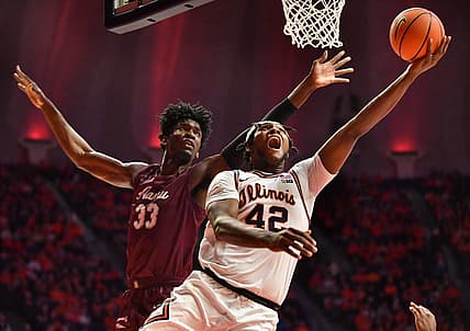 Dec 17, 2022; Champaign, Illinois, USA; Illinois Fighting Illini forward Dain Dainja (42) drives to the basket as Alabama A&M Bulldogs center Olisa Blaise Akonobi (33) defends during the first half at State Farm Center. Mandatory Credit: Ron Johnson-USA TODAY Sports