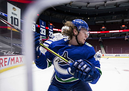 Mar 4, 2021; Vancouver, British Columbia, CAN; Toronto Maple Leafs defenseman Morgan Rielly (44) checks Vancouver Canucks forward Adam Gaudette (96) in the second period at Rogers Arena. Mandatory Credit: Bob Frid-USA TODAY Sports