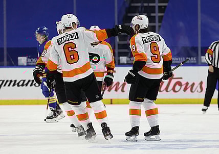 Mar 29, 2021; Buffalo, New York, USA;  Philadelphia Flyers defenseman Ivan Provorov (9) celebrates with teammates after scoring an overtime goal against the Buffalo Sabres at KeyBank Center. Mandatory Credit: Timothy T. Ludwig-USA TODAY Sports