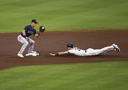 Apr 28, 2021; Houston, Texas, USA; Houston Astros right fielder Kyle Tucker (30) slides safely into second base as Seattle Mariners second baseman Sam Haggerty (0) fields a throw during the second inning at Minute Maid Park. Mandatory Credit: Troy Taormina-USA TODAY Sports