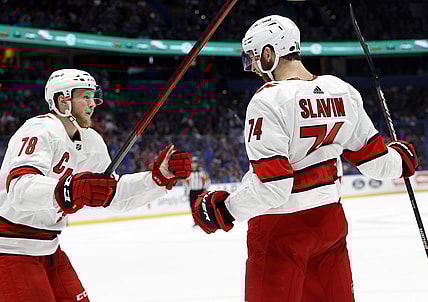 Jun 5, 2021; Tampa, Florida, USA; Carolina Hurricanes defenseman Jaccob Slavin (74) is congratulated by Carolina Hurricanes left wing Steven Lorentz (78)  as he scores a goal against the Tampa Bay Lightning during the second period in game four of the second round of the 2021 Stanley Cup Playoffs at Amalie Arena. Mandatory Credit: Kim Klement-USA TODAY Sports