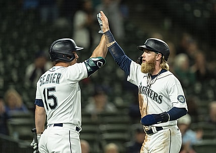 Jun 14, 2021; Seattle, Washington, USA; Seattle Mariners designated hitter Jake Fraley (28) is congratulated by third baseman Kyle Seager (15) after scoring a run on a double by first baseman Ty France (23) off of Minnesota Twins relief pitcher Luke Farrell (51) during the fifth inning of a game at T-Mobile Park. Mandatory Credit: Stephen Brashear-USA TODAY Sports