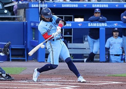 Jun 17, 2021; Buffalo, New York, USA;  Toronto Blue Jays shortstop Bo Bichette (11) hits a base hit during the first inning against the New York Yankees at Sahlen Field. Mandatory Credit: Timothy T. Ludwig-USA TODAY Sports