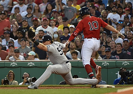 Jun 26, 2021; Boston, Massachusetts, USA; New York Yankees first baseman Luke Voit (59) stretches to make the catch but Boston Red Sox right fielder Hunter Renfroe (10) beats out the throw during the third inning at Fenway Park. Mandatory Credit: Bob DeChiara-USA TODAY Sports