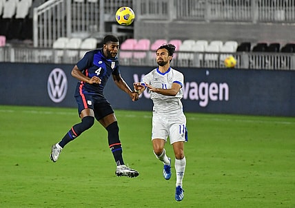 Dec 9, 2020; Fort Lauderdale, Florida, USA; United States defender Mark McKenzie (4) heads the ball in front of El Salvador forward Joaquin Rivas (11) during the second half at Inter Miami CF Stadium. Mandatory Credit: Jasen Vinlove-USA TODAY Sports