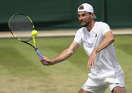 Jul 1, 2022; London, United Kingdom; Maxime Cressy (USA) returns a shot during his match against Jack Sock (USA) on day five at All England Lawn Tennis and Croquet Club. Mandatory Credit: Susan Mullane-USA TODAY Sports