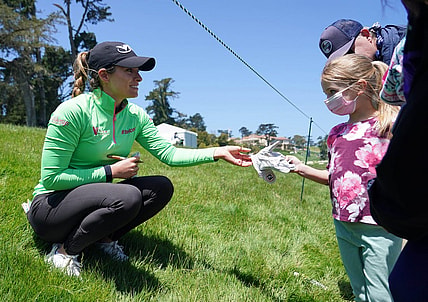 Jun 6, 2021; San Francisco, California, USA; Gaby Lopez gives a signed glove to a young golf spectator during the final round of the U.S. Women's Open golf tournament at The Olympic Club. Mandatory Credit: Kyle Terada-USA TODAY Sports