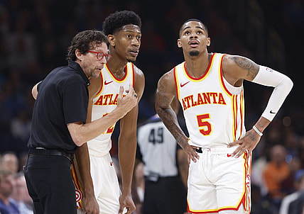 Nov 6, 2023; Oklahoma City, Oklahoma, USA; Atlanta Hawks head coach Quin Snyder talks with Atlanta Hawks forward De'Andre Hunter (12) and guard Dejounte Murray (5) during a break in play against the Oklahoma City Thunder in the second quarter at Paycom Center. Mandatory Credit: Alonzo Adams-USA TODAY Sports