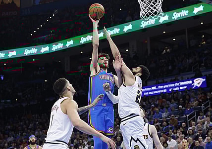 Jan 31, 2024; Oklahoma City, Oklahoma, USA; Oklahoma City Thunder forward Chet Holmgren (7) shoots as Denver Nuggets guard Jamal Murray (27) defends during the second half at Paycom Center. Mandatory Credit: Alonzo Adams-USA TODAY Sports