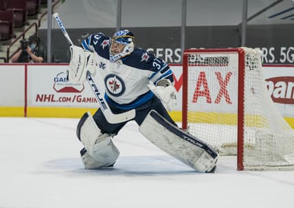 Mar 22, 2021; Vancouver, British Columbia, CAN; Winnipeg Jets goalie Connor Hellebuyck (37) makes a save against the Vancouver Canucks  in the first period at Rogers Arena. Mandatory Credit: Bob Frid-USA TODAY Sports