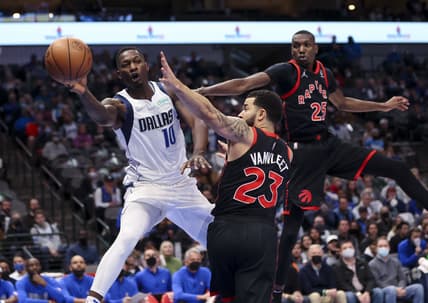 Jan 19, 2022; Dallas, Texas, USA;  Dallas Mavericks forward Dorian Finney-Smith (10) passes around Toronto Raptors guard Fred VanVleet (23) and  forward Chris Boucher (25) during the first quarter at American Airlines Center. Mandatory Credit: Kevin Jairaj-USA TODAY Sports