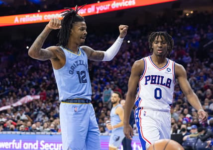Jan 31, 2022; Philadelphia, Pennsylvania, USA; Memphis Grizzlies guard Ja Morant (12) reacts in front of Philadelphia 76ers guard Tyrese Maxey (0) after dunking the ball during the third quarter at Wells Fargo Center. Mandatory Credit: Bill Streicher-USA TODAY Sports