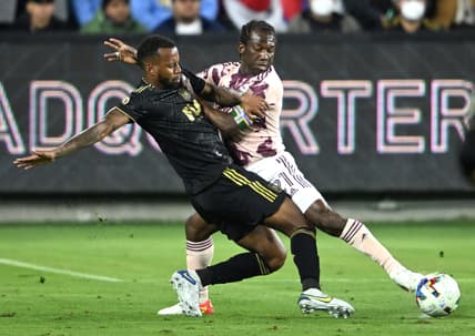 Mar 6, 2022; Los Angeles, California, USA; Portland Timbers midfielder Diego Chara (21) and Los Angeles FC defender Jesus Murillo (3) go for the ball in the first half at Banc of California Stadium. Mandatory Credit: Jayne Kamin-Oncea-USA TODAY Sports