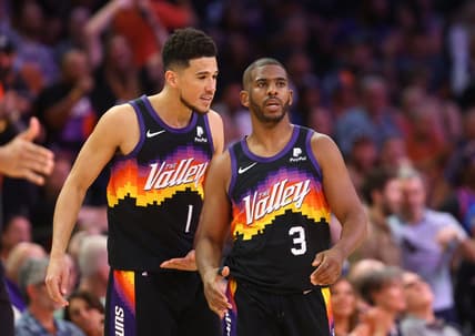 Mar 27, 2022; Phoenix, Arizona, USA; Phoenix Suns guard Devin Booker (1) and guard Chris Paul (3) against the Philadelphia 76ers at Footprint Center. Mandatory Credit: Mark J. Rebilas-USA TODAY Sports