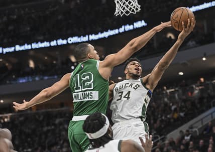 Apr 7, 2022; Milwaukee, Wisconsin, USA;  Milwaukee Bucks forward Giannis Antetokounmpo (34) takes a shot against Boston Celtics forward Grant Williams (12) in the second quarter at Fiserv Forum. Mandatory Credit: Benny Sieu-USA TODAY Sports