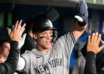 Sep 27, 2022; Toronto, Ontario, CAN;  New York Yankees center fielder Aaron Judge (99) celebrates in the dugout with team mates after scoring against the Toronto Blue Jays in the third inning at Rogers Centre. Mandatory Credit: Dan Hamilton-USA TODAY Sports