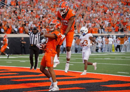 Oklahoma State receiver Bryson Green (9) celebrates beside receiver Rashod Owens (10) after scoring a touchdown in the fourth quarter of a 41-34 win against Texas on Saturday at Boone Pickens Stadium in Stillwater.

cover main