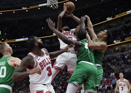 Oct 24, 2022; Chicago, Illinois, USA; Chicago Bulls forward Derrick Jones Jr. (5) goes up for a shot on Boston Celtics forward Noah Vonleh (4) during the first half at United Center. Mandatory Credit: David Banks-USA TODAY Sports