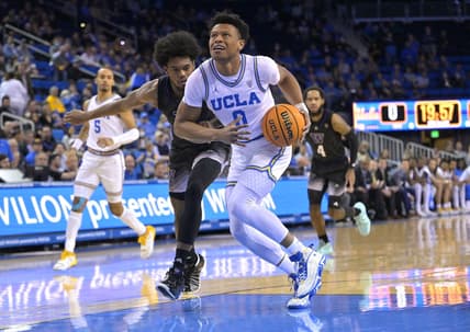 Feb 2, 2023; Los Angeles, California, USA; UCLA Bruins guard Jaylen Clark (0) is fouled by Washington Huskies forward Keion Brooks (1) as he drives to the basket in the first half at Pauley Pavilion presented by Wescom. Mandatory Credit: Jayne Kamin-Oncea-USA TODAY Sports