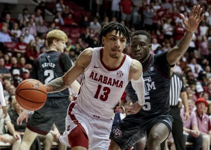 Mar 2, 2022; Tuscaloosa, Alabama, USA; Alabama Crimson Tide guard Jahvon Quinerly (13) drives the baseline around Texas A&M Aggies guard Hassan Diarra (5) during the second half at Coleman Coliseum. Mandatory Credit: Butch Dill-USA TODAY Sports