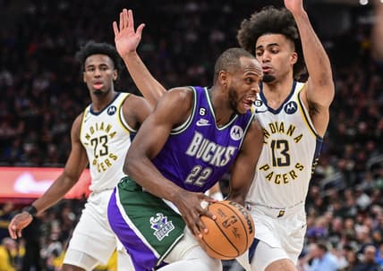 Mar 16, 2023; Milwaukee, Wisconsin, USA; Milwaukee Bucks forward Khris Middleton (22) drives for the basket against Indiana Pacers forward Jordan Nwora (13) in the second quarter at Fiserv Forum. Mandatory Credit: Benny Sieu-USA TODAY Sports