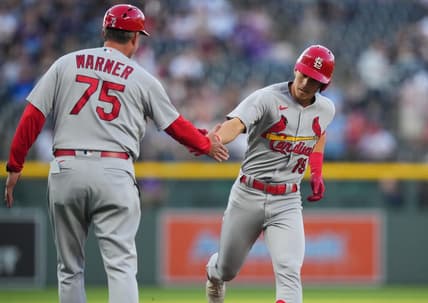 Apr 11, 2023; Denver, Colorado, USA; St. Louis Cardinals short stop Tommy Edman (19) celebrates his solo home run with third base coach Ron Warner (75) in the first inning against the Colorado Rockies at Coors Field. Mandatory Credit: Ron Chenoy-USA TODAY Sports