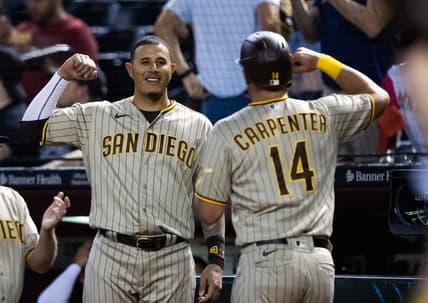 Apr 20, 2023; Phoenix, Arizona, USA; San Diego Padres first baseman Matt Carpenter (14) celebrates with teammate Manny Machado after hitting a solo home run in the fourth inning against the Arizona Diamondbacks at Chase Field. Mandatory Credit: Mark J. Rebilas-USA TODAY Sports