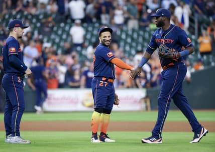 Jul 31, 2023; Houston, Texas, USA; Houston Astros third baseman Alex Bregman (2) and second baseman Jose Altuve (27) and  left fielder Yordan Alvarez (44) celebrate the win against the Cleveland Guardians  after defeating the Cleveland Guardians at Minute Maid Park. Mandatory Credit: Thomas Shea-USA TODAY Sports