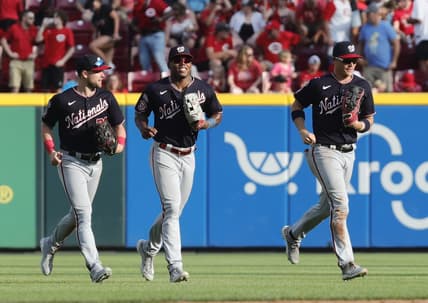 Aug 5, 2023; Cincinnati, Ohio, USA; Washington Nationals outfielders Lane Thomas (left) Stone Garrett (middle) and  Alex Call (right) run off the field after the Nationals defeated the Cincinnati Reds at Great American Ball Park. Mandatory Credit: David Kohl-USA TODAY Sports