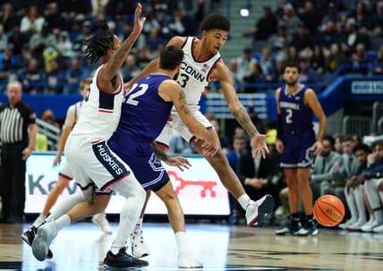 Nov 11, 2023; Hartford, Connecticut, USA; UConn Huskies forward Jaylin Stewart (3) and guard Stephon Castle (5) defend against Stonehill Skyhawks Pano Pavlidis (22) in the first half at XL Center. Mandatory Credit: David Butler II-USA TODAY Sports